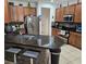 Well-equipped kitchen featuring stainless steel appliances, granite countertops, and breakfast bar at 3265 Stratton Cir, Kissimmee, FL 34744