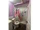 Small full bathroom area with a white shower and toilet and a pink floral curtain at 332 S Observatory Dr, Orlando, FL 32835