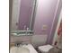 Full bathroom features a toilet, sink, mirror and shower with a pink floral curtain at 332 S Observatory Dr, Orlando, FL 32835
