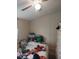 Bedroom features a ceiling fan and a bed piled high with pillows and blankets at 332 S Observatory Dr, Orlando, FL 32835