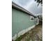 The exterior of the home showcases light green siding and a small window at 332 S Observatory Dr, Orlando, FL 32835