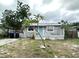 Charming single-story home with a cozy front porch, a pop of color with the blue door, and a simple, clean landscape at 332 S Observatory Dr, Orlando, FL 32835