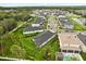 Aerial view showcases homes with large manicured lawns, and features a community lake with fountain at 3635 Arbordale Loop, Sanford, FL 32771
