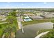 An aerial view of a community pool and lake, surrounded by single Gathering homes and lush landscaping at 3635 Arbordale Loop, Sanford, FL 32771