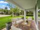 Inviting covered porch with comfortable seating, perfect for outdoor relaxation overlooking the backyard at 3635 Arbordale Loop, Sanford, FL 32771