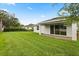 Well-maintained backyard with a patio, lush green lawn, and mature landscaping for privacy at 3635 Arbordale Loop, Sanford, FL 32771