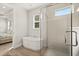 A luxurious bathroom showcasing a soaking tub and a frameless glass shower at 3635 Arbordale Loop, Sanford, FL 32771