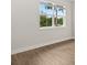 Bright, airy bedroom with wood-look flooring and a large window overlooking the landscape at 3635 Arbordale Loop, Sanford, FL 32771