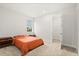 Bedroom with minimalist style, carpeted floor, orange bed, and an open closet at 3635 Arbordale Loop, Sanford, FL 32771