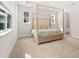 Bright bedroom featuring a four-poster bed, neutral walls, and large windows for natural light at 3635 Arbordale Loop, Sanford, FL 32771