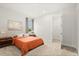 Bright bedroom with an orange bed, minimalist art, and an attached walk-in closet at 3635 Arbordale Loop, Sanford, FL 32771