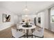 Open-concept dining area near kitchen, perfect for entertaining with modern white furniture at 3635 Arbordale Loop, Sanford, FL 32771