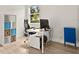 Bright home office space featuring a large window, a modern desk, and ample storage options at 3635 Arbordale Loop, Sanford, FL 32771