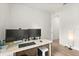 A tidy home office with two monitors, a clean desk, and a view into another room at 3635 Arbordale Loop, Sanford, FL 32771