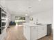 Island kitchen boasts stainless appliances, quartz counters, and seamless flow into the living space at 3635 Arbordale Loop, Sanford, FL 32771