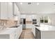 Bright, modern kitchen with white cabinets, stainless steel appliances, and a stylish backsplash at 3635 Arbordale Loop, Sanford, FL 32771