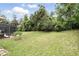 Lush green backyard with the side view of the screened in pool area provides a private outdoor space at 394 Hickory Springs Pl, Debary, FL 32713