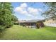 A spacious, verdant backyard featuring a screened-in pool area, perfect for relaxing or entertaining at 394 Hickory Springs Pl, Debary, FL 32713