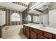 Bathroom showcasing dual vanities, a garden tub, and a step in shower at 394 Hickory Springs Pl, Debary, FL 32713