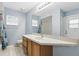 Bathroom with blue walls, vanity, and a combined shower-tub at 394 Hickory Springs Pl, Debary, FL 32713