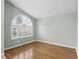Cozy bedroom with hardwood floors, a vaulted ceiling, and a large window for natural light at 394 Hickory Springs Pl, Debary, FL 32713