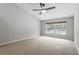 Spacious bedroom with ceiling fan, neutral walls, carpet flooring and a bright window at 394 Hickory Springs Pl, Debary, FL 32713