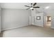 Large bedroom with a walk in closet, neutral walls, carpet and ceiling fan at 394 Hickory Springs Pl, Debary, FL 32713
