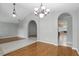 Open dining area with hardwood floors, a chandelier, and seamless access to adjacent living spaces at 394 Hickory Springs Pl, Debary, FL 32713
