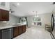 View of kitchen with backyard through the window, showing stainless appliances and dark cabinets at 394 Hickory Springs Pl, Debary, FL 32713