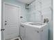 Laundry room with a washer-dryer, white door, and wire shelving at 394 Hickory Springs Pl, Debary, FL 32713