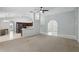 Open-concept living room featuring neutral walls, ceiling fan, and arched entryway at 394 Hickory Springs Pl, Debary, FL 32713