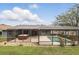 Enjoy the serene backyard featuring a screened pool, hot tub, and ample patio space at 394 Hickory Springs Pl, Debary, FL 32713