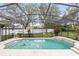 Backyard in-ground pool featuring a screened enclosure at 394 Hickory Springs Pl, Debary, FL 32713