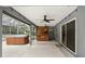Enclosed patio featuring an outdoor bar and in-ground hot tub, with access to the backyard at 394 Hickory Springs Pl, Debary, FL 32713