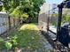 Fenced backyard shows lawn, foliage, and screened enclosure at 415 Seville Ave, Altamonte Springs, FL 32714