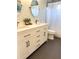 Bright bathroom with dual sinks, modern fixtures, and a shower with curtain at 415 Seville Ave, Altamonte Springs, FL 32714