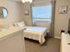Bright bedroom with neutral walls, a dresser, and a cozy bed at 415 Seville Ave, Altamonte Springs, FL 32714