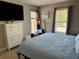 Bedroom features a large window with natural light, tv and comfortable bedding at 415 Seville Ave, Altamonte Springs, FL 32714