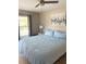 Comfortable bedroom features a large window, neutral walls, and plush bedding for relaxation at 415 Seville Ave, Altamonte Springs, FL 32714