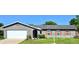 Charming single Gathering home showcasing a gray exterior, orange shutters, and a well-manicured front yard at 415 Seville Ave, Altamonte Springs, FL 32714