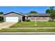 Charming single-story home with a well-maintained lawn and vibrant orange shutters, offering a welcoming curb appeal at 415 Seville Ave, Altamonte Springs, FL 32714