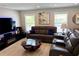 Cozy living room featuring comfortable leather seating, ambient lighting, and stylish decor for a relaxing living space at 415 Seville Ave, Altamonte Springs, FL 32714
