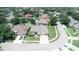 Aerial view of a residential neighborhood showcasing a charming single-story home with mature landscaping at 4906 Keaton Crest Dr, Orlando, FL 32837