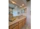 Bathroom vanity with a large mirror and a tray with flowers at 4906 Keaton Crest Dr, Orlando, FL 32837