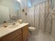 Bathroom with a shower and decorative shower curtain, vanity and toilet at 4906 Keaton Crest Dr, Orlando, FL 32837