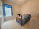 Bright bedroom with a blue bedspread, carpet flooring and a big window at 4906 Keaton Crest Dr, Orlando, FL 32837