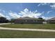 View of home featuring manicured lawn with green grass and blue sky at 4906 Keaton Crest Dr, Orlando, FL 32837