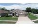 Lovely single-story home with a three-car garage, well-maintained lawn, and beautiful curb appeal at 4906 Keaton Crest Dr, Orlando, FL 32837