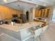 Well-lit kitchen features stainless appliances, ample counter space, and seating at the breakfast bar at 4906 Keaton Crest Dr, Orlando, FL 32837