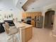 The open kitchen features stainless appliances and breakfast bar, seamlessly connecting to the living area at 4906 Keaton Crest Dr, Orlando, FL 32837